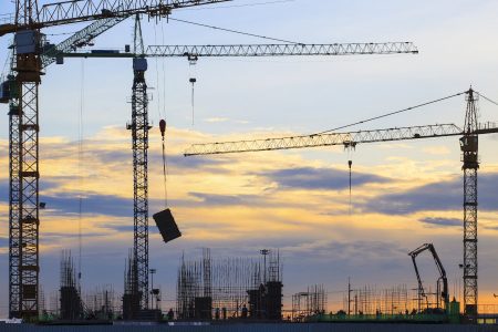 crane of building construction against beautiful dusky sky